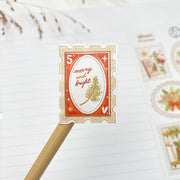 Winter Stamps kiss-cut sticker on a pencil: a red merry and bright postage stamp