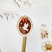 Winter Stamps kiss-cut sticker on a pencil: a white dove on a red oval stamp