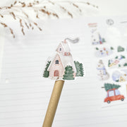 Winter Village kiss-cut sticker on a pencil: a pink house with a chimney in the snow
