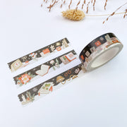 Cozy Mind Winter Days washi tape roll, 15mm, unrolled next to three strips, on near-black: a writing desk with notebooks, a desk lamp, letter tiles and poinsettia