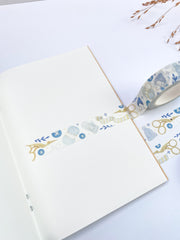 Winter Knitting washi tape as a strip across an open notebook page, roll on the edge
