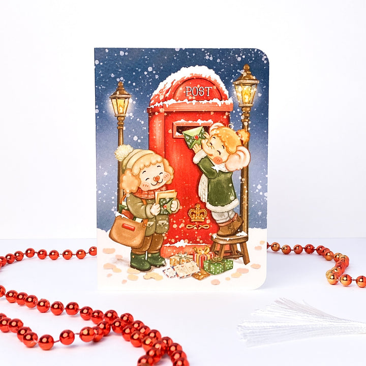 Sending Post Christmas card without text: Tuk Tuk and Stroop post their letters at a red post box in the snow