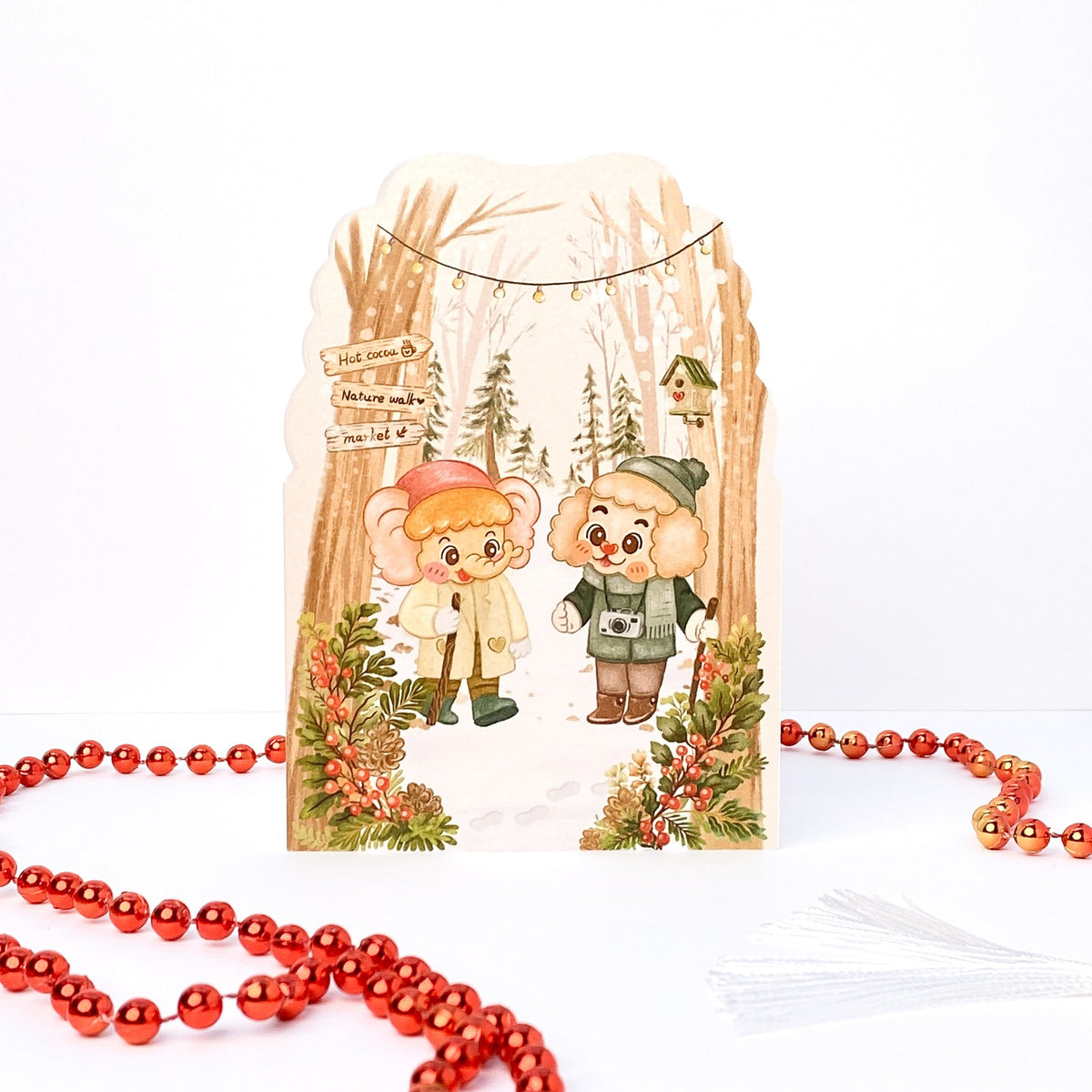 Walking in the Woods Christmas card without text, scalloped top: Tuk Tuk and Stroop on a winter walk under fairy lights
