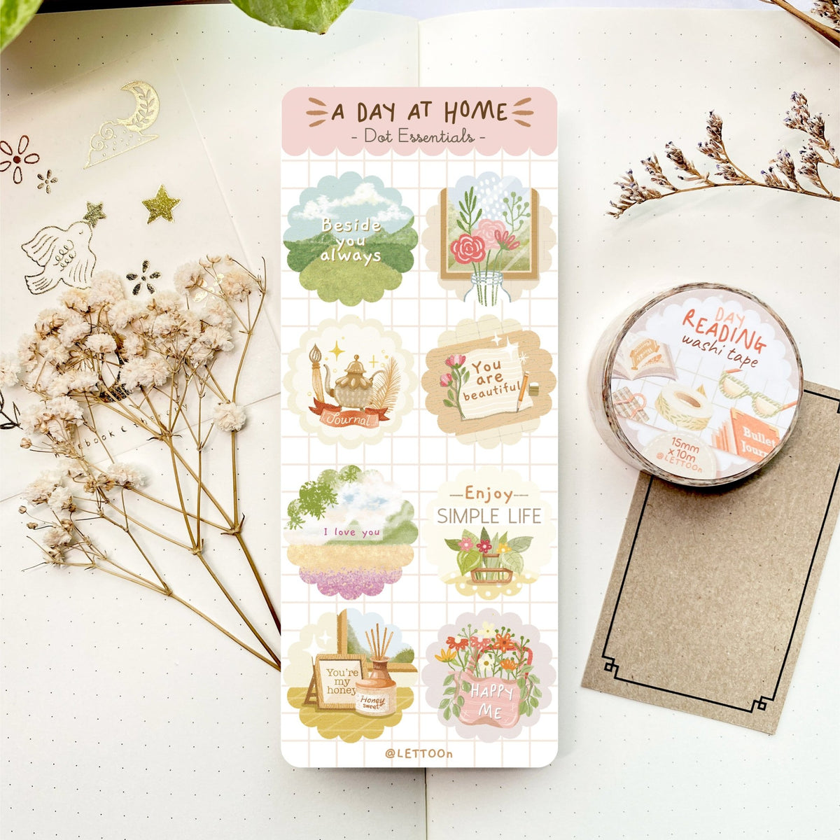 Premium Handmade Sticker Sheet A Day At Home 105mm x 148mm - a sheet on the table with a white flower branch, a purple flower branch, a washi tape, an opened notebook