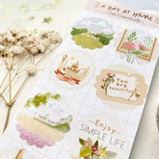 Premium Handmade Sticker Sheet A Day At Home 105mm x 148mm - a sheet on the table with a white flower branch, an opened notebook