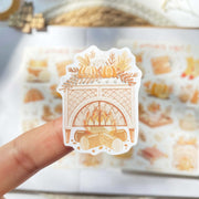 Premium Handmade Sticker Sheet Autumn in my Heart 105mm x 148mm - a piece on hand and a sheet on the table with an opened notebook