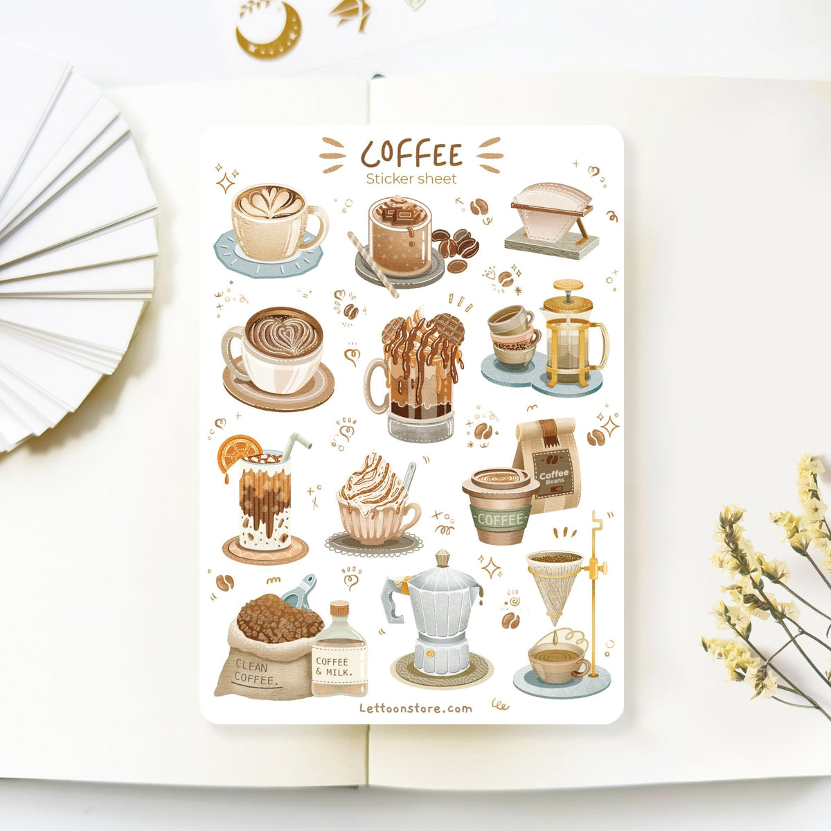 Premium Handmade Sticker Sheet Coffee 105mm x 148mm - a sheet on the table with a white flower branch, an opened notebook