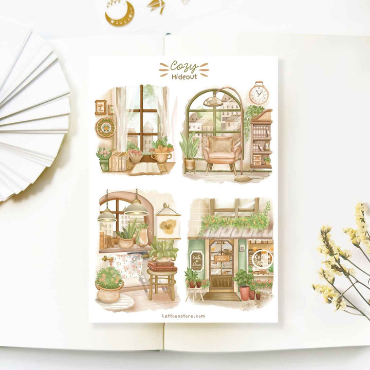 Premium Handmade Sticker Sheet Cozy Hideout 105mm x 148mm - 4 pieces on the table with a white flower branch, an opened notebook