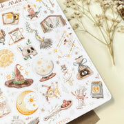Premium Handmade Sticker Sheet Dark Magic 105mm x 148mm - a sheet on the table with a white flower branch