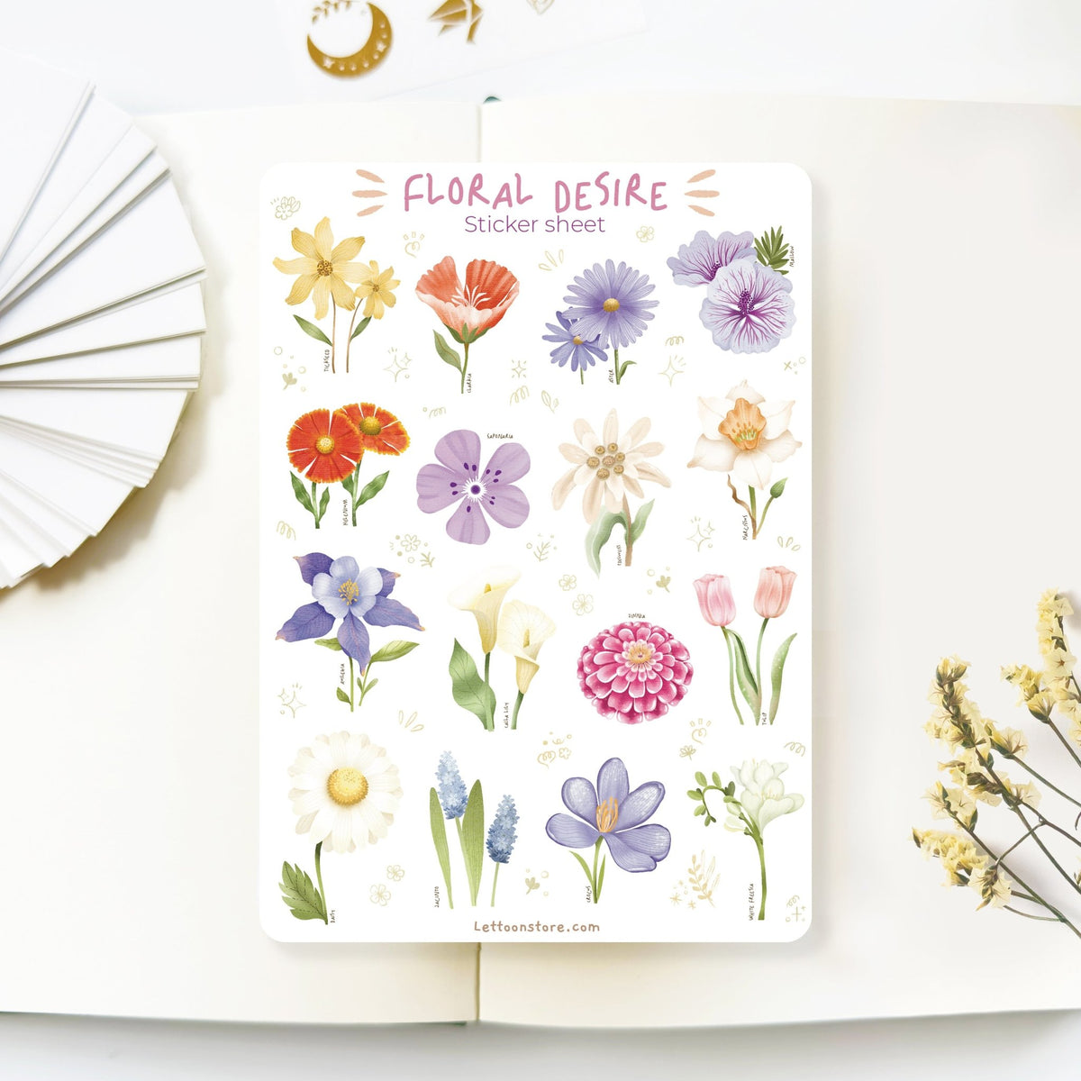 Premium Handmade Sticker Sheet Floral Desire 105mm x 148mm - a sheet on the table with a white flower branch, an opened notebook