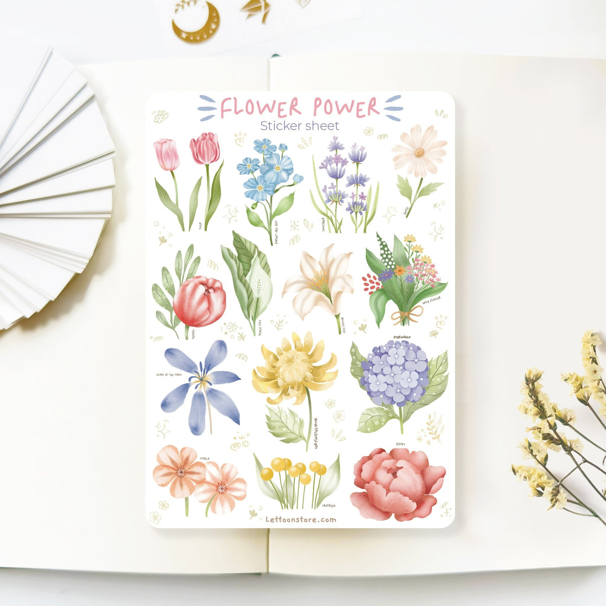 Premium Handmade Sticker Sheet Floral Power 105mm x 148mm - a sheet on the table with a white flower branch, an opened notebook