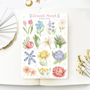Premium Handmade Sticker Sheet Floral Power 105mm x 148mm - a sheet on the table with a white flower branch, an opened notebook