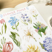 Premium Handmade Sticker Sheet Floral Power 105mm x 148mm - a sheet on the table with a white flower branch, an opened notebook