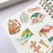 Premium Handmade Sticker Sheet Into The Wild 105mm x 148mm - 9 pieces on the hand note on the table