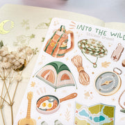 Premium Handmade Sticker Sheet Into The Wild 105mm x 148mm - a sheet on the table with a white flower branch, an opened notebook