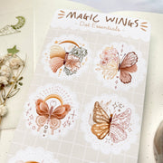 Premium Handmade Sticker Sheet Magic Wings 105mm x 148mm - a sheet on the table with a white flower branch, an opened notebook