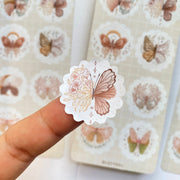 Premium Handmade Sticker Sheet Magic Wings 105mm x 148mm - a piece on the finger and 2 sheets on the table 