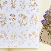 Premium Handmade Sticker Sheet Mellow Flower 105mm x 148mm - a sheet on the table with a purple flower branch, an opened notebook