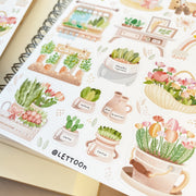 Premium Handmade Sticker Sheet Spring Garden 105mm x 148mm - a sheet on the table with an opened notebook