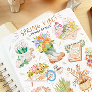 Premium Handmade Sticker Sheet Spring Vibes 105mm x 148mm - a sheet on the table with an opened notebook