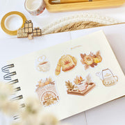 Premium Handmade Sticker Sheet Sweet Pumpkin 105mm x 148mm - 6 pieces on a handbook on the table with an opened notebook